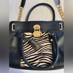 Emma Fox shoulder bag with zebra and gold metal accents.